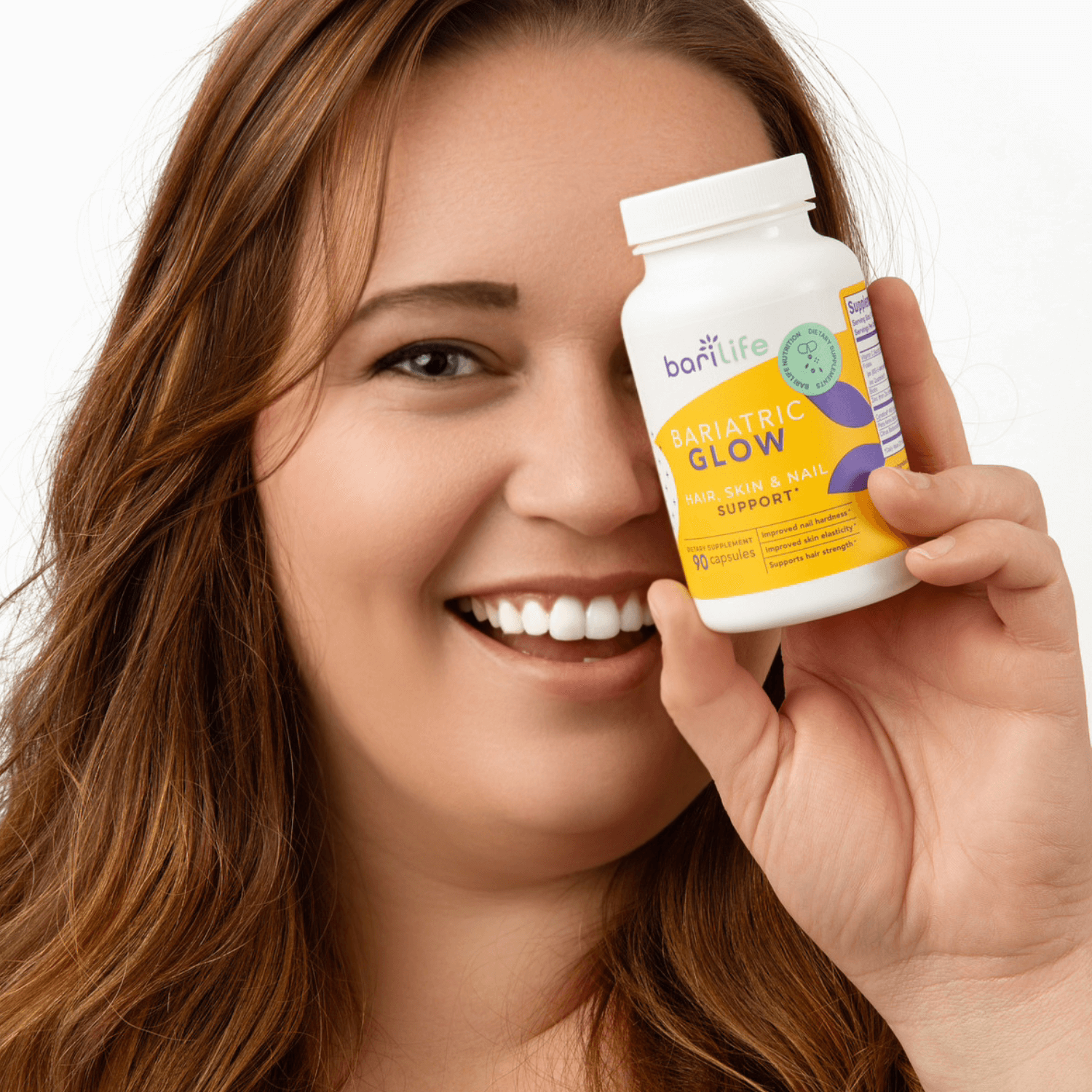 Happy woman holding Bariatric Glow supplement for hair, skin, and nails support, promoting post-op confidence.